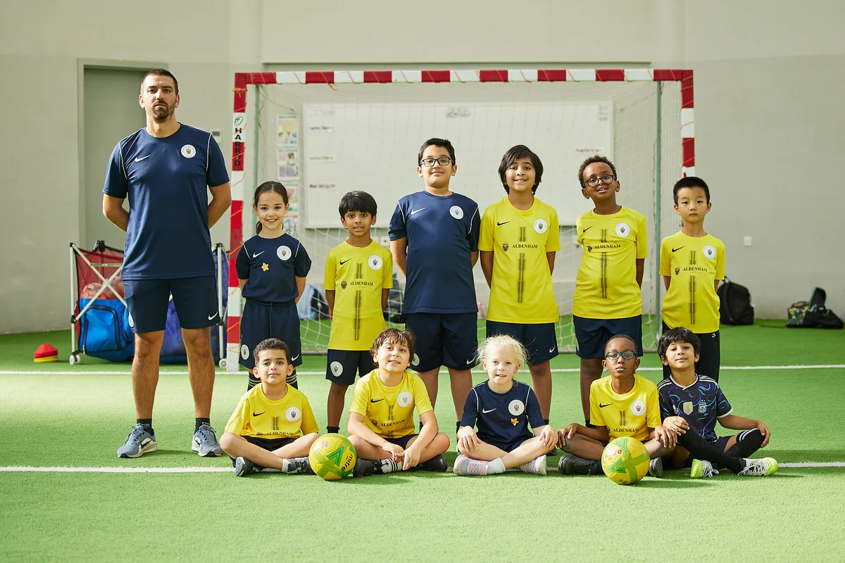 Academy players and coaches on the indoor pitch at Aldenham Prep, Riyadh