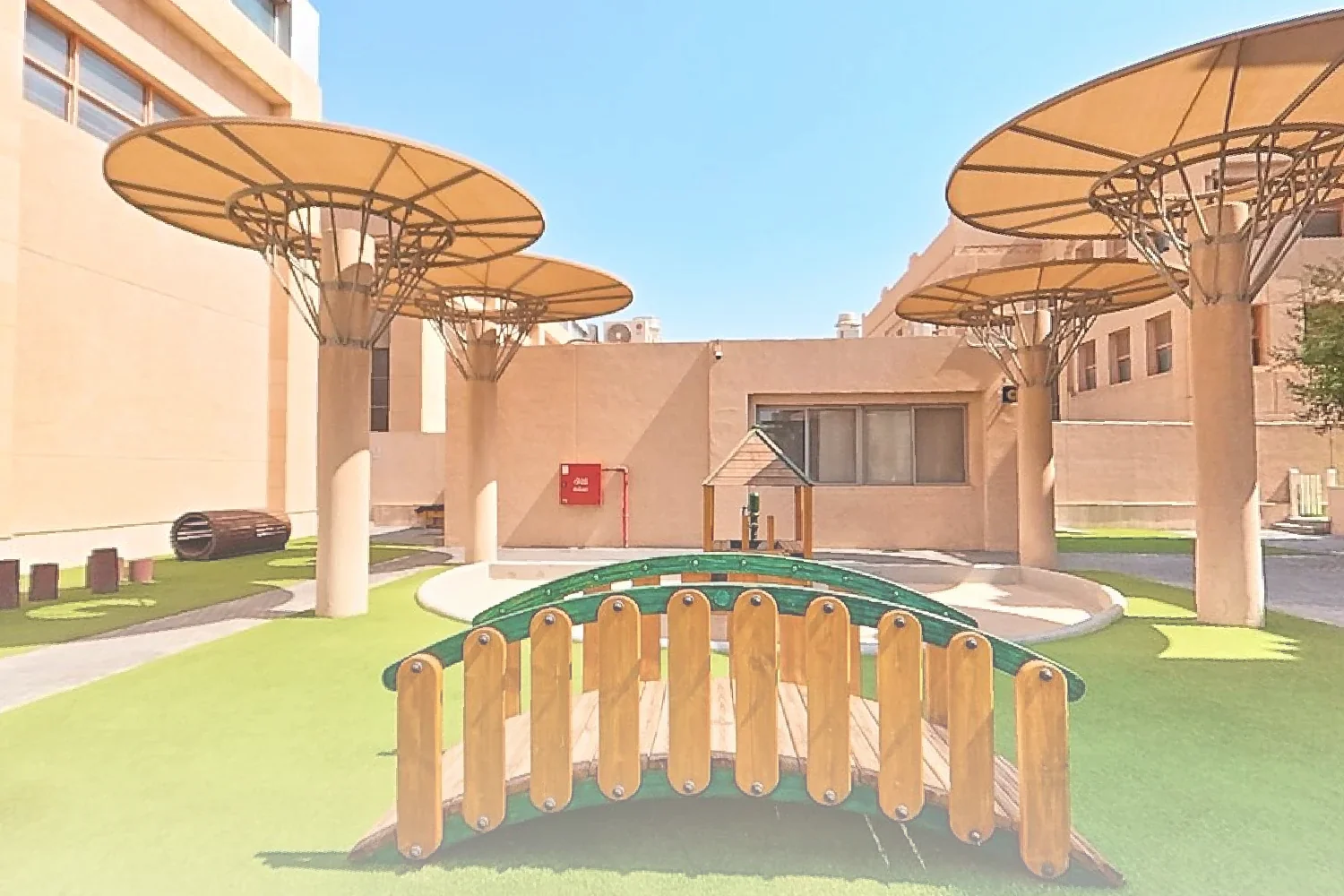 Early Years outdoor play area at Aldenham School Riyadh with shaded play structures, a wooden bridge and a sandpit